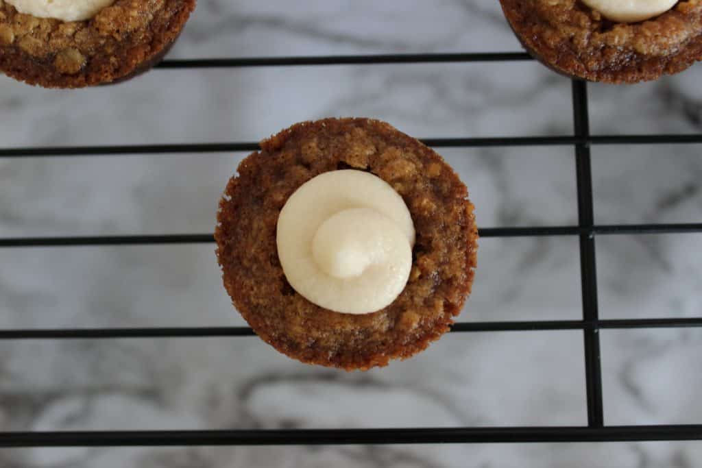 Filled mini oatmeal cream pie cookie cup on cooling rack.