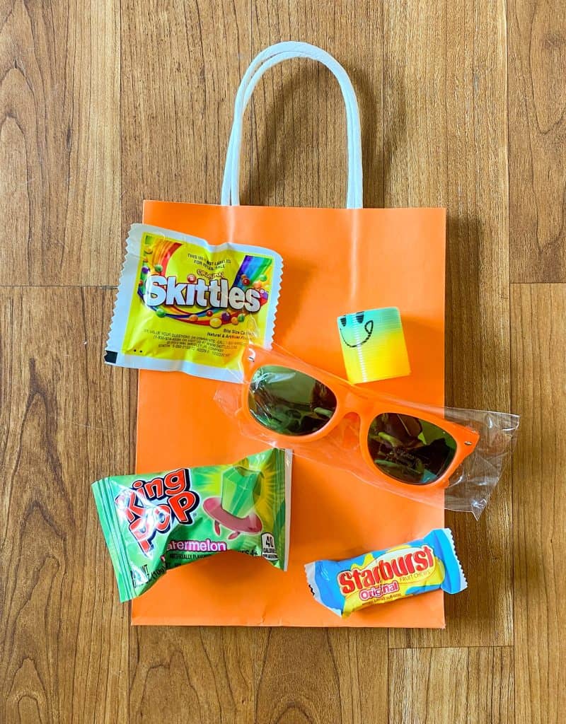 favor bag with sunglasses, Ring Pop, Skittles, Starbursts, and slinky