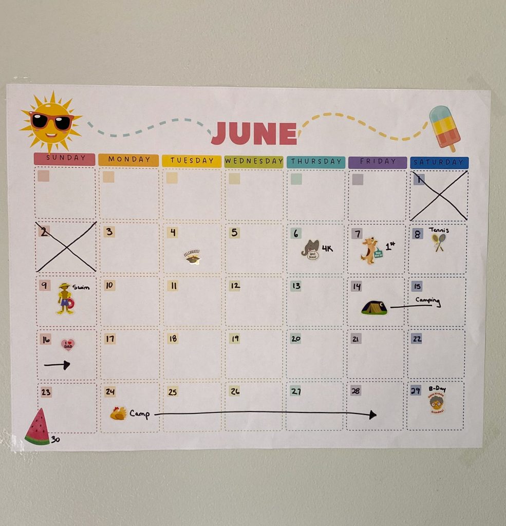 Large June calendar filled out with stickers and summer plans