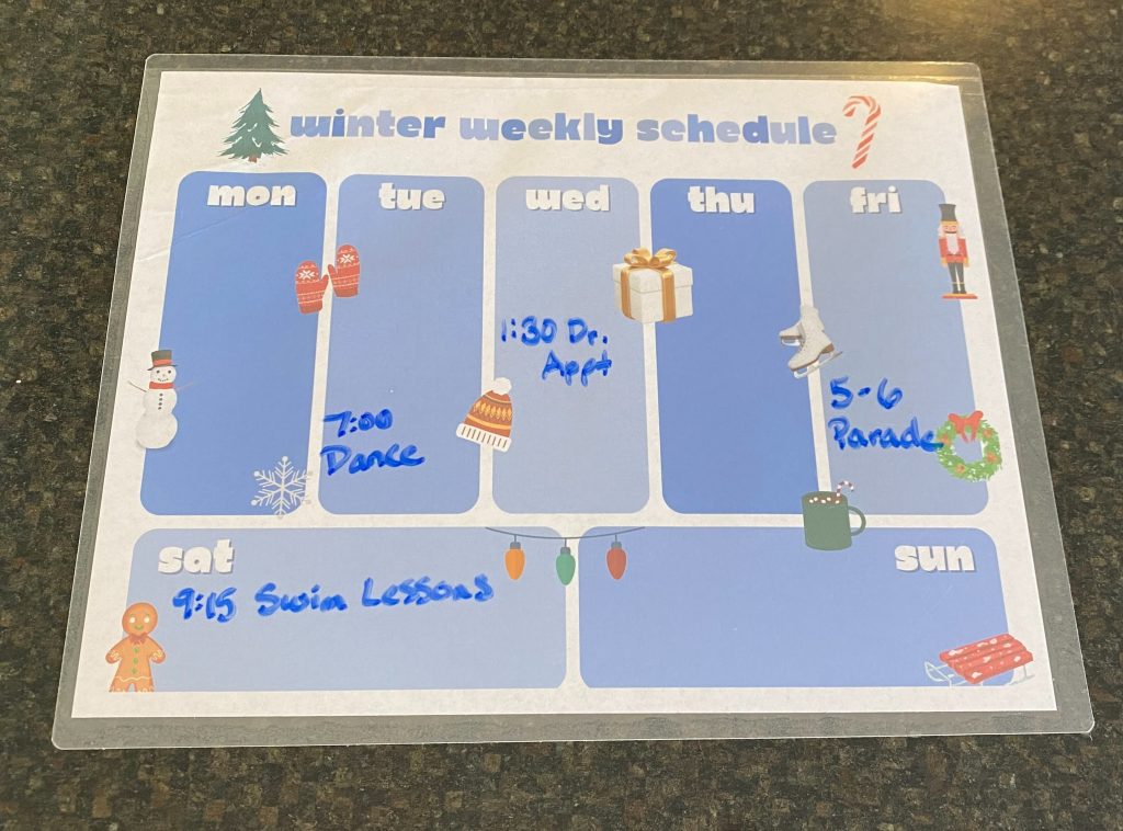 schedule written on a dry erase winter-themed weekly calendar