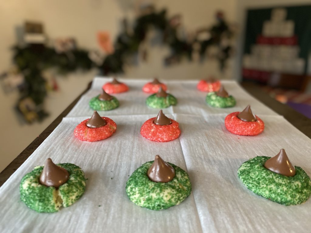 red and green sugar cookies with chocolate Kiss in the center