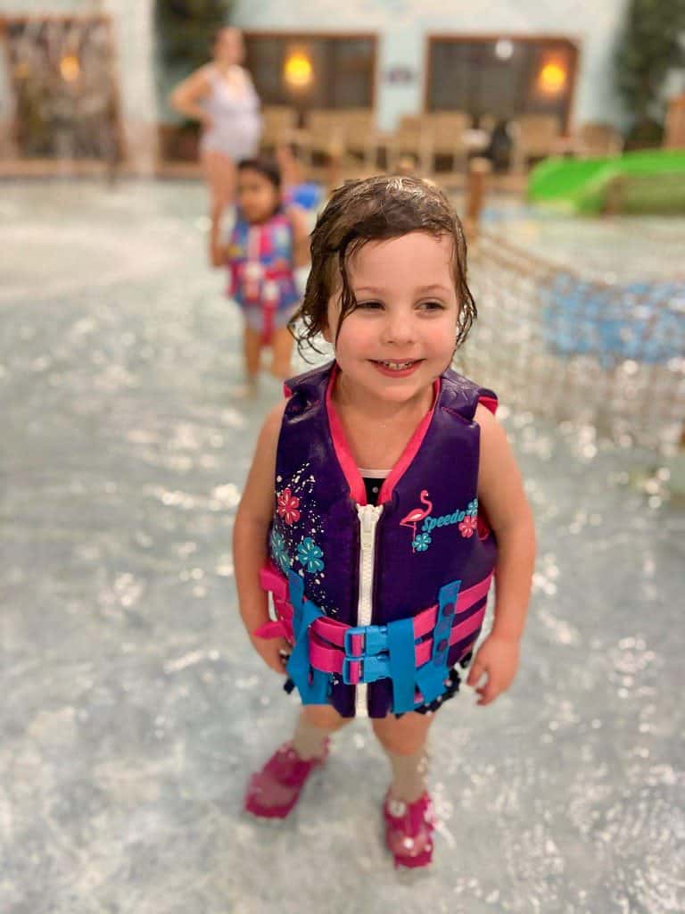 toddler in pool with life jacket