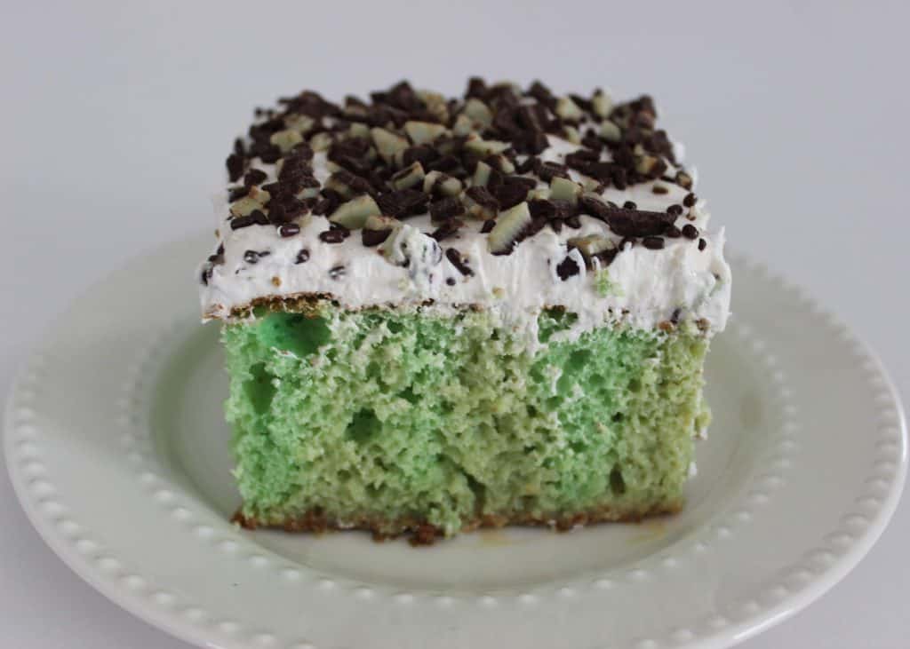 a square of cake on a white plate